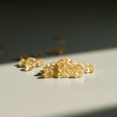Vitamin B12 tablets on a gray surface with a dark background